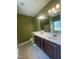 Bathroom with double sink vanity, tile flooring, and a large mirror and window at 66 Saddle Ln, Lillington, NC 27546