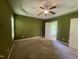 Large primary bedroom with a ceiling fan, carpet, and en-suite bathroom with natural light at 66 Saddle Ln, Lillington, NC 27546