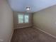 This empty bedroom includes a neutral wall color and carpet at 66 Saddle Ln, Lillington, NC 27546