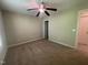 Bright bedroom with carpet flooring, a ceiling fan, and a view into an attached bathroom at 66 Saddle Ln, Lillington, NC 27546