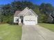 Charming home featuring a two-car garage, well-manicured lawn, and inviting curb appeal at 66 Saddle Ln, Lillington, NC 27546