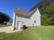 Side of home showing access door, utility connections, and a well-maintained lawn at 66 Saddle Ln, Lillington, NC 27546