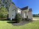 Home exterior featuring manicured landscaping, columns, and a screened porch at 66 Saddle Ln, Lillington, NC 27546