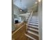 Bright living room featuring hardwood floors, a fireplace, and staircase access to the second floor at 66 Saddle Ln, Lillington, NC 27546