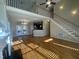 Open living room with wood floors, fireplace, and doors to backyard at 66 Saddle Ln, Lillington, NC 27546