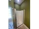 Bathroom featuring glass shower door with tile surround, and natural light from window at 66 Saddle Ln, Lillington, NC 27546
