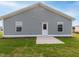 The backyard has a concrete patio, green lawn, and a home with light gray siding and white trim at 67 Fern Ridge Dr, Cameron, NC 28326
