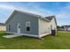 The backyard includes a green lawn, a home with light gray siding, and a concrete patio at 67 Fern Ridge Dr, Cameron, NC 28326