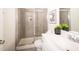 Tiled bathroom featuring a glass enclosed shower, large vanity, and modern fixtures at 67 Fern Ridge Dr, Cameron, NC 28326