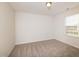 Bare bedroom with neutral walls, carpet, and a window letting in bright, natural light at 67 Fern Ridge Dr, Cameron, NC 28326