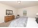 Bedroom with neutral walls, carpet, woven headboard, grey bedding, and wood dresser at 67 Fern Ridge Dr, Cameron, NC 28326