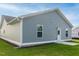 Home exterior showcasing light gray siding, green grass, and professionally installed gutters at 67 Fern Ridge Dr, Cameron, NC 28326
