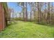 Backyard featuring a staircase and many tall, thin trees at 6702 Huntsboro Rd, Oxford, NC 27565