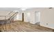 Open basement area with hard wood floors, a staircase, and multiple doors at 6702 Huntsboro Rd, Oxford, NC 27565