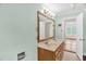 Bathroom featuring double vanity and mirror, and view into the next room at 6702 Huntsboro Rd, Oxford, NC 27565
