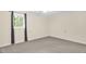 Bedroom with neutral walls and carpet plus a window with views to the outside at 6702 Huntsboro Rd, Oxford, NC 27565