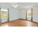 Bright bedroom with hardwood floors, ceiling fan, and multiple windows at 6702 Huntsboro Rd, Oxford, NC 27565