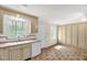 Kitchen space with light-colored cabinets, tile flooring, and exterior door at 6702 Huntsboro Rd, Oxford, NC 27565