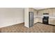 Bright kitchen featuring stainless steel refrigerator, light wood cabinets, and tile flooring at 6702 Huntsboro Rd, Oxford, NC 27565