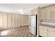 Kitchen with light-colored cabinets, tile flooring, and stainless steel refrigerator at 6702 Huntsboro Rd, Oxford, NC 27565