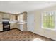 Bright kitchen with light colored cabinetry, white appliances, and tile floors at 6702 Huntsboro Rd, Oxford, NC 27565