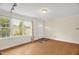 Inviting living room boasts wood floors, neutral walls, and large window for bright natural light at 6702 Huntsboro Rd, Oxford, NC 27565