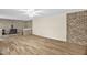 Spacious living room featuring hardwood floors, a ceiling fan, and a brick fireplace at 6702 Huntsboro Rd, Oxford, NC 27565