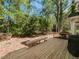 Wooden deck and fence surrounded by mature trees in the backyard at 6909 Clear Sailing Ln, Raleigh, NC 27615