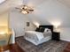 Bedroom features a sloped ceiling, hardwood floors, ceiling fan and a large rug at 6909 Clear Sailing Ln, Raleigh, NC 27615