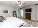 Cozy bedroom with a ceiling fan, television, dresser, and a comfy bed at 6909 Clear Sailing Ln, Raleigh, NC 27615