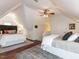 Sloped ceiling bedroom featuring hardwood floors, ceiling fan and two beds at 6909 Clear Sailing Ln, Raleigh, NC 27615