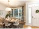 Bright dining area with large windows, hardwood floors, and stylish furnishings at 6909 Clear Sailing Ln, Raleigh, NC 27615