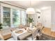 Dining space with large windows bringing in natural light and hardwood floors at 6909 Clear Sailing Ln, Raleigh, NC 27615