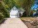 Charming two-story home with a two-car garage, landscaped yard, and a welcoming facade at 6909 Clear Sailing Ln, Raleigh, NC 27615