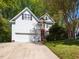 Charming two-story home with white siding, black shutters, and well-manicured lawn at 6909 Clear Sailing Ln, Raleigh, NC 27615