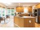 Bright kitchen featuring natural wood cabinetry, stainless steel appliances, and a kitchen island at 6909 Clear Sailing Ln, Raleigh, NC 27615