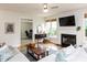 Cozy living room with a fireplace, lots of natural light, and hardwood flooring at 6909 Clear Sailing Ln, Raleigh, NC 27615