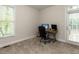 Bright office space featuring a desk with computer, natural light from the window, and a door to the exterior at 6909 Clear Sailing Ln, Raleigh, NC 27615