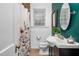 Well-maintained bathroom featuring updated fixtures, floral shower curtain at 7110 Hunter Hill Rd, Rocky Mount, NC 27804
