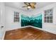 Cozy bedroom featuring mountain mural, natural light, and hardwood floors at 7110 Hunter Hill Rd, Rocky Mount, NC 27804