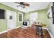 Eat in kitchen area with wood floors, green walls, and a white ceiling fan at 7110 Hunter Hill Rd, Rocky Mount, NC 27804