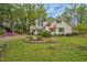 Charming home with green shutters and a well-maintained yard surrounded by mature trees at 7110 Hunter Hill Rd, Rocky Mount, NC 27804