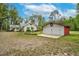 Exterior view of a charming house with a red and white garage on a spacious, tree-filled lot at 7110 Hunter Hill Rd, Rocky Mount, NC 27804