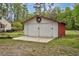 Exterior shot of a white and red garage with a concrete pad, decorated with a wreath at 7110 Hunter Hill Rd, Rocky Mount, NC 27804