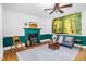Bright living room featuring fireplace, ceiling fan and blue sofa at 7110 Hunter Hill Rd, Rocky Mount, NC 27804