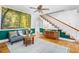 Open-concept living room featuring stairs, wood floors, and natural light at 7110 Hunter Hill Rd, Rocky Mount, NC 27804