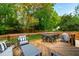 Well-maintained backyard with a spacious wooden deck, outdoor seating, and a grill, ideal for entertainment at 7409 Fiesta Way, Raleigh, NC 27615