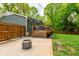 Backyard area featuring a patio with a fire pit, leading up to a wooden deck, perfect for outdoor entertaining at 7409 Fiesta Way, Raleigh, NC 27615