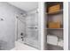 Bathroom with tub/shower combo, gray wallpaper, and built-in shelves at 7409 Fiesta Way, Raleigh, NC 27615