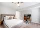 Cozy bedroom featuring carpet, a ceiling fan, and a dedicated desk area perfect for work or study at 7409 Fiesta Way, Raleigh, NC 27615